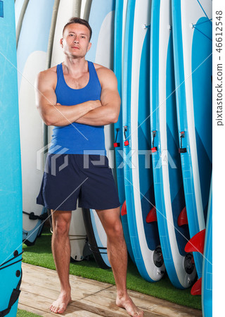 guy with boards for surfing 46612548