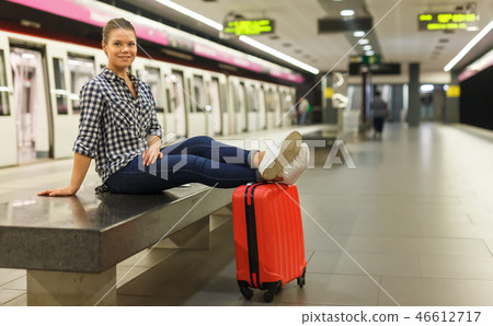 Nice girl sitting on bench at metro station Nice girl sitting on bench at metro station 46612717