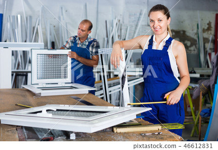 Girl working in workshop for assembling plastic windows Girl working in workshop for assembling plastic windows 46612831