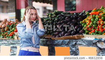 Woman is choosing fresh aubergine Woman is choosing fresh aubergine 46612838