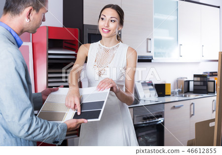 Young assistant working with customer in store Young assistant working with customer in store 46612855