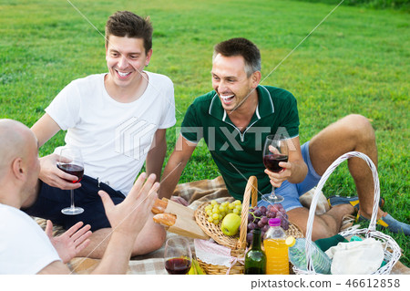 Three happy men friends enjoying life on picnic Three happy men friends enjoying life on picnic 46612858