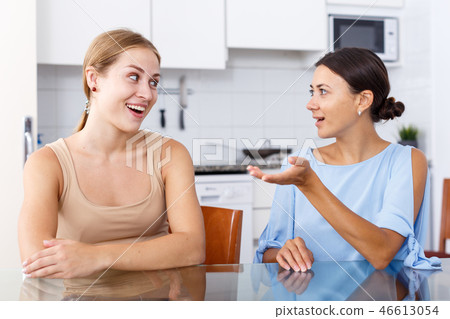Two friendly girls having emotional conversation Two friendly girls having emotional conversation 46613054