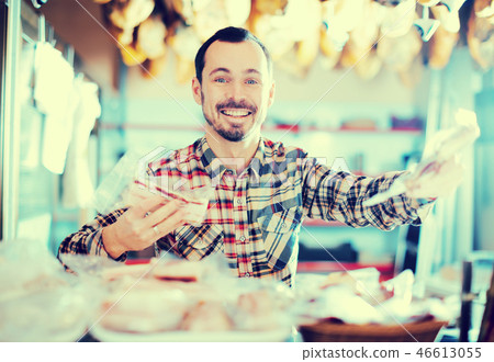 Seller offering sorts of meat 46613055