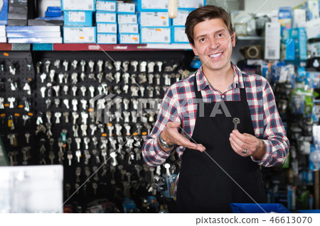 Portrait of smiling employee showing keys Portrait of smiling employee showing keys 46613070