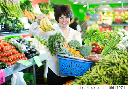 Adult female taking fruits and vegetables Adult female taking fruits and vegetables 46613074