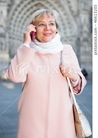 mature female tourist talking on phone 46613205