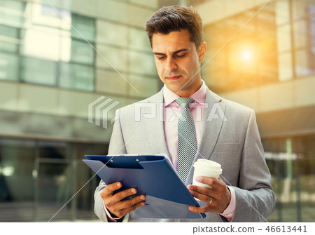 Serious manager reading papers Serious manager reading papers 46613441