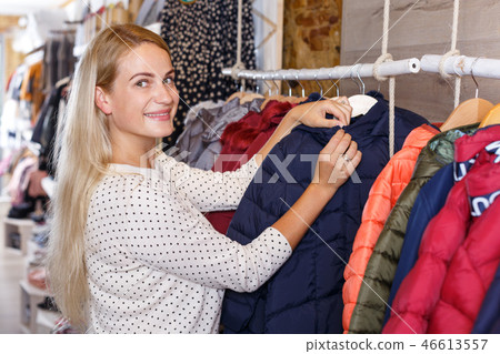 Girl choosing kids clothes in boutique 46613557