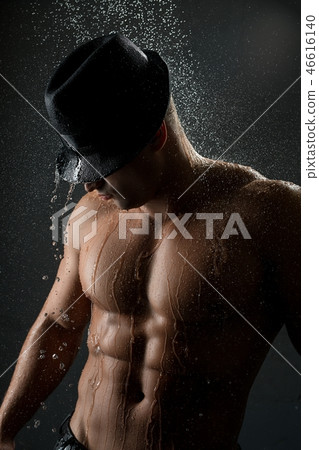 Young muscular man in shower in the dark Young muscular man in shower in the dark 46616140