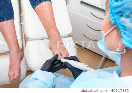 Podology treatment. Podiatrist treats foot. Podiatry doctor or dermatologist treats the patient in Podology treatment. Podiatrist treats foot. Podiatry doctor or dermatologist treats the patient in 46617185