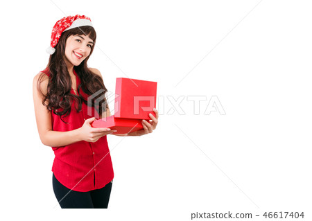 Woman in santa hat opening Christmas gift box isolated on white with copyspace. Happy girl unpacking 46617404