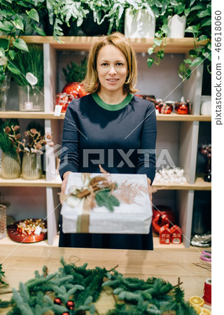 Seller shows gift box with handmade wrapping Seller shows gift box with handmade wrapping 46618060