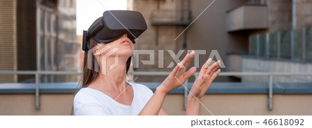 Young woman wearing virtual reality goggles headset, vr box outdoors. Connection, technology, new Young woman wearing virtual reality goggles headset, vr box outdoors. Connection, technology, new 46618092