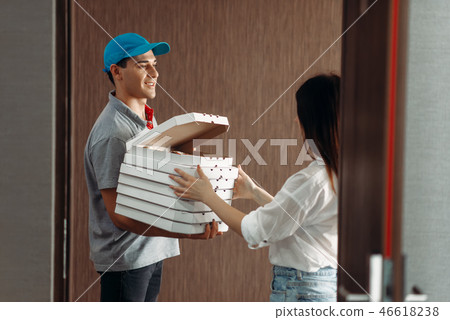 Delivery boy shows pizza to female customer Delivery boy shows pizza to female customer 46618238