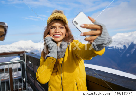 Young woman taking a selfie in winter holiday in mountain. 46618774