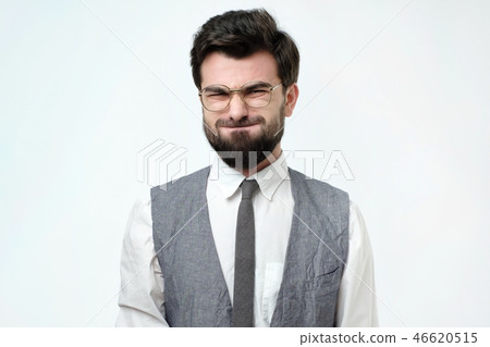 Funny young man grimacing, inflating cheeks, holding his breath. 46620515