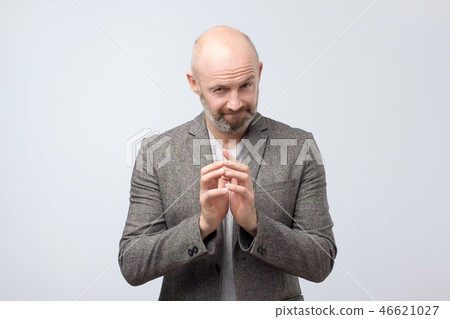 Cunning tricky mature man thinking with hand together over white background. 46621027