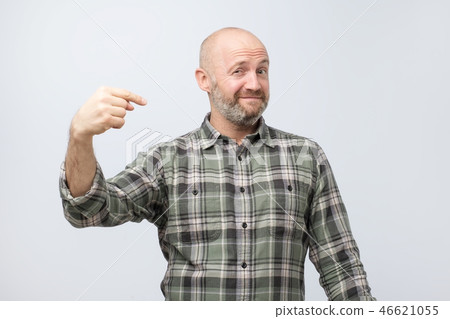 Man proud of himself over gray background. Man proud of himself over gray background. 46621055