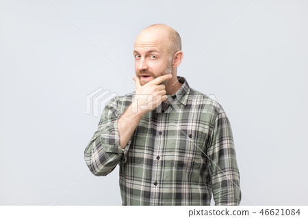 Middle aged man thinking, expressing leadership reflections and concerns, trying to make a decision. Middle aged man thinking, expressing leadership reflections and concerns, trying to make a decision. 46621084