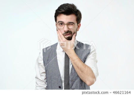 Doubtful bearded young spanish man looking with mistrust. Doubtful bearded young spanish man looking with mistrust. 46621164