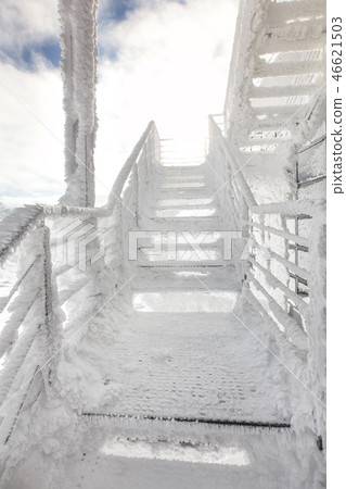 Stairs rail, completely covered with ice crystals 46621503
