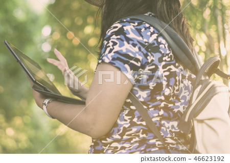 A woman use tablet for business during travel A woman use tablet for business during travel 46623192
