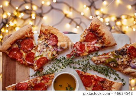 Christmas and New Year atmosphere. Hot Italian pizza with melting tomato, pepperoni and cheese on a 46624548