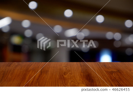 wooden table over blur restaurant, shopping mall wooden table over blur restaurant, shopping mall 46626455