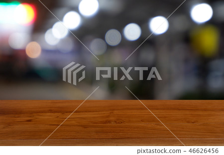 wooden table over blur restaurant, shopping mall wooden table over blur restaurant, shopping mall 46626456