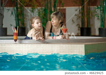 Relaxing in swimming-pool 46629425
