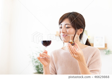 Lifestyle Woman enjoying wine and chocolate 46629868