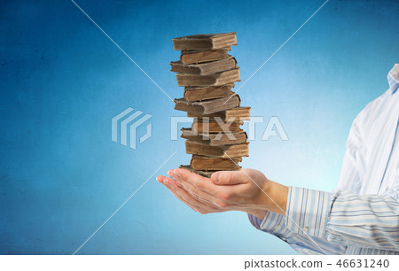 Stack of books in palms Stack of books in palms 46631240