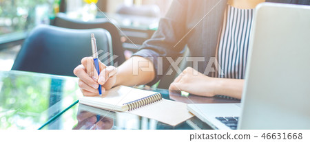 Business woman writing on a notebook. 46631668