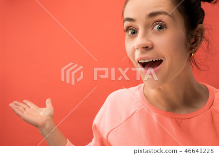 Beautiful woman looking suprised isolated on coral Beautiful woman looking suprised isolated on coral 46641228