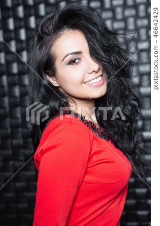 Portrait of playful woman in red dress. Portrait of playful woman in red dress. 46642429