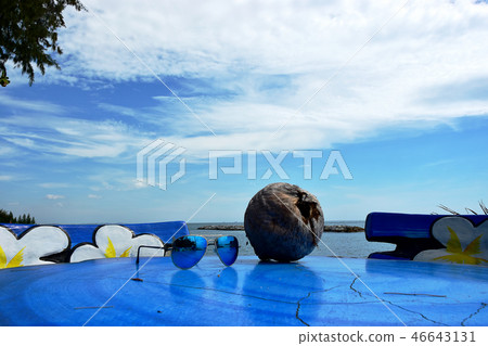The Sun Glasses and Coconut on the Sea beach The Sun Glasses and Coconut on the Sea beach 46643131