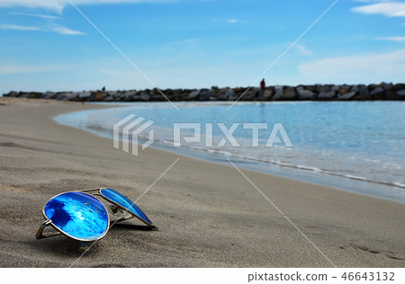 The Sun Glasses and Coconut on the Sea beach The Sun Glasses and Coconut on the Sea beach 46643132