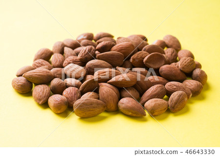 Almonds scattered on the table. Selective focus. Almonds scattered on the table. Selective focus. 46643330