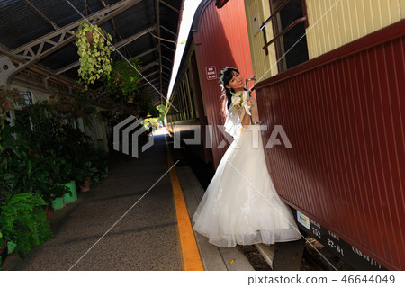 A side view of the bride trying to board a sightseeing train at Kuranda Station A side view of the bride trying to board a sightseeing train at Kuranda Station 46644049