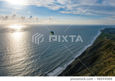 Flying tandem paragliders over the sea and near the mountains, beautiful landscape view 46644066