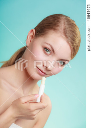 woman applying balsam for lips 46645673