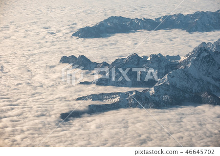 Above of cloudy cluster with rocky mountain Above of cloudy cluster with rocky mountain 46645702