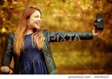 Ginger girl taking selfie. 46646087