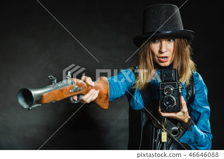 Steampunk with old retro camera and pistol. 46646088