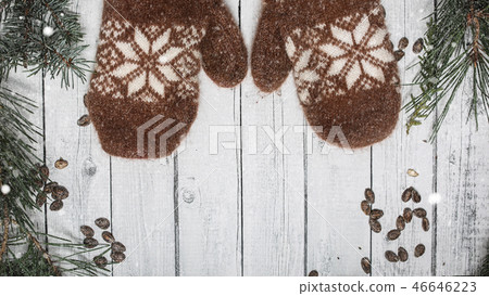 Brown mittens and spruce branches with snow on white wooden background. Holiday banner design 16 in 46646223