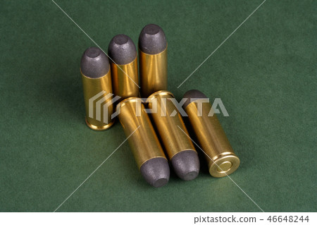 Western-style revolver cartridges on green  46648244