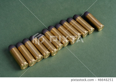 Western-style revolver cartridges on green  46648251
