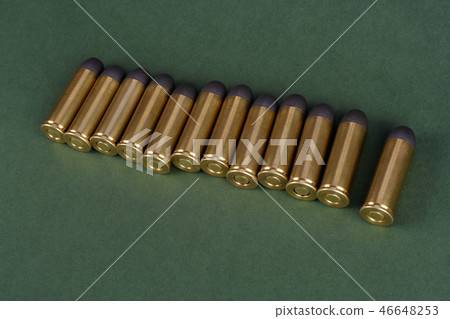 Western-style revolver cartridges on green  46648253