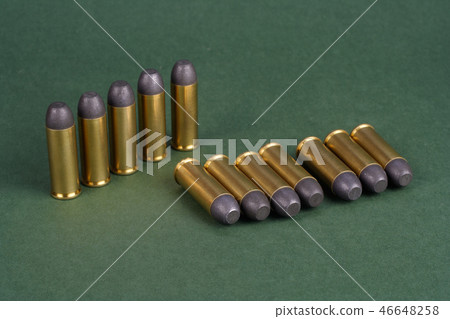 Western-style revolver cartridges on green  46648258